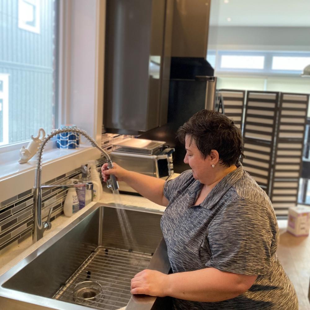 Tidying and Organizing Woman cleaning large kitchen sink.